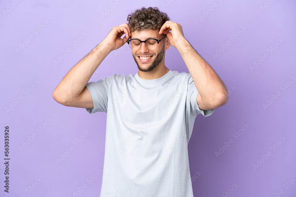 Delivery caucasian man isolated on purple background laughing Delivery caucasian man isolated on purple background laughing