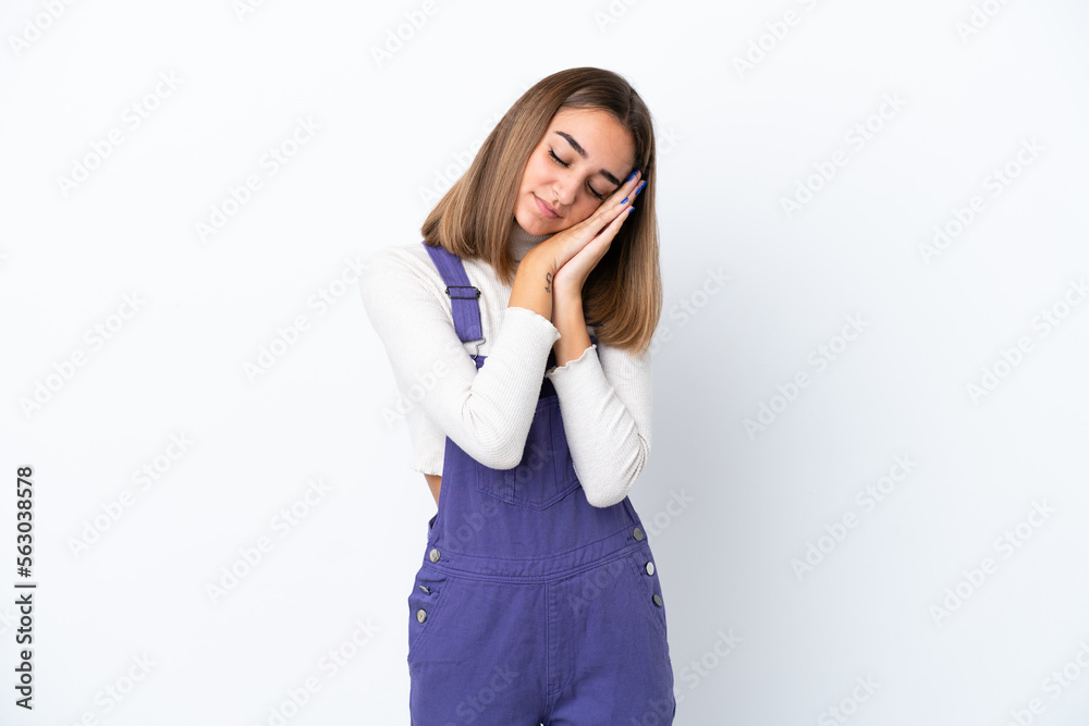 Young caucasian woman isolated on white background making sleep gesture in dorable expression Young caucasian woman isolated on white background making sleep gesture in dorable expression
