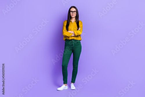 Full length portrait of clever successful person folded hands posing isolated on purple color background