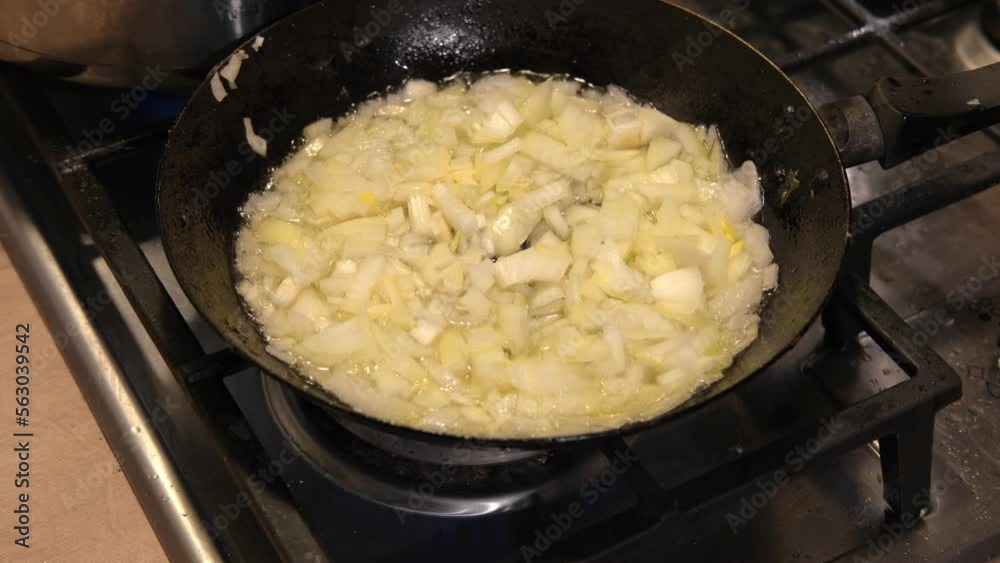 Crispy Fried Onion Bits with oil in the pan. Deep fried onion. Homemade