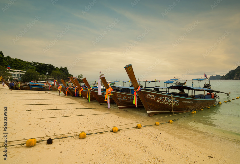 The famous Ton Sai beach at sunset. Traditional tour boats on the beach and beautiful bay view. Thailand's top tourist destinations The famous Ton Sai beach at sunset. Traditional tour boats on the beach and beautiful bay view. Thailand's top tourist destinations