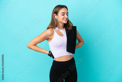 Young sport woman isolated on blue background suffering from backache for having made an effort