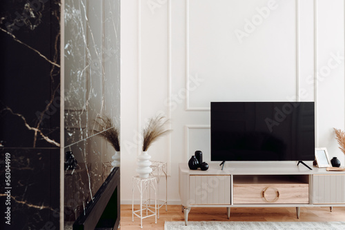 Interior design details - stylish modern furniture, tv stand fireplace and wooden floors in residential home