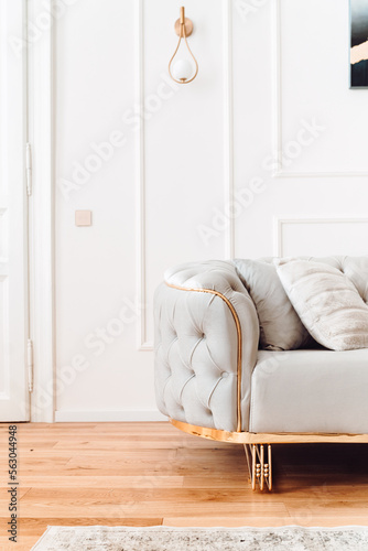 Stylish living room details and modern design with sofa, details of couch fabric and pillows. Boho design, comfortable sofa with textures and modern furniture next to fireplace