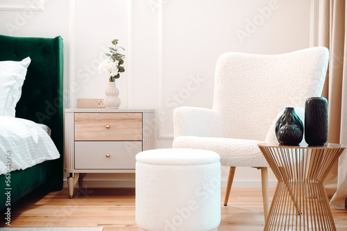 Beautiful bedroom interior with lounge chair, stylish and modern furniture