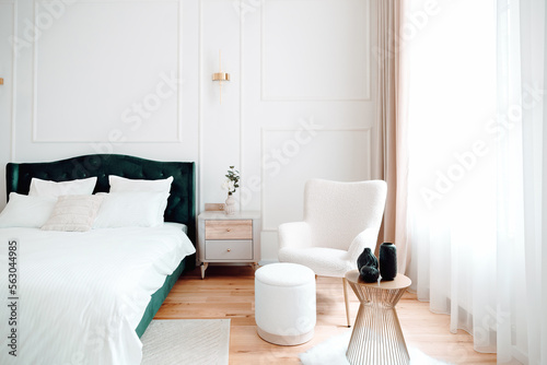 Beautiful bedroom interior with lounge chair, stylish and modern furniture