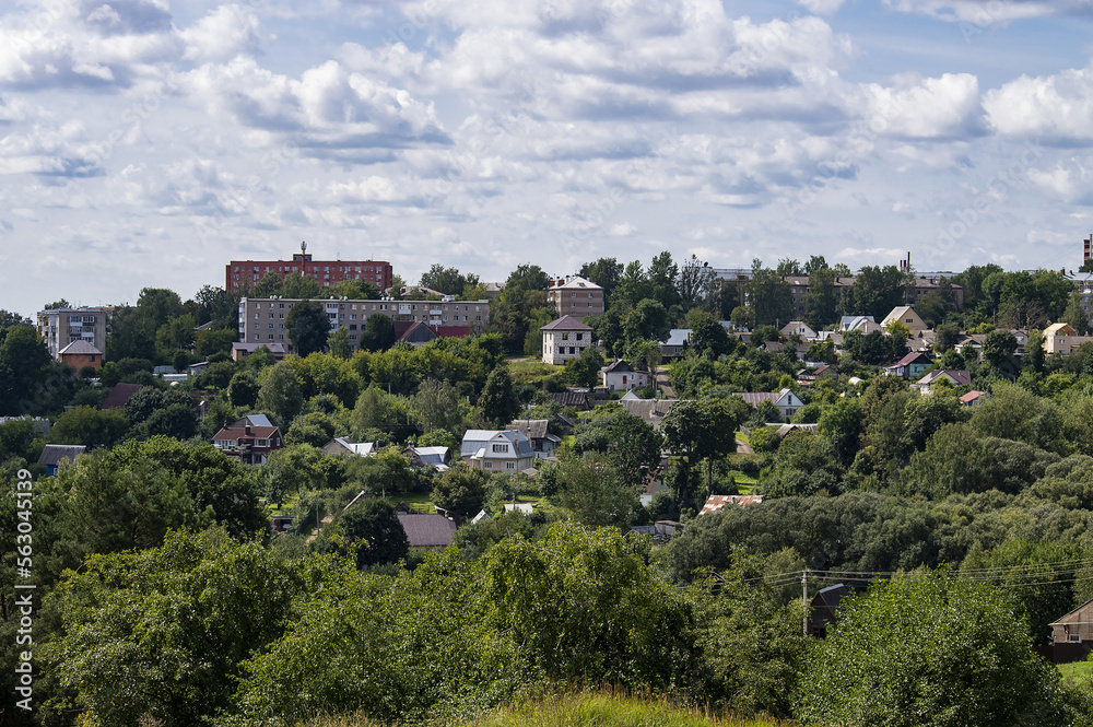 View of low-rise buildings and private houses surrounded by many trees View of low-rise buildings and private houses surrounded by many trees