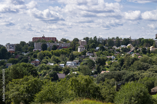 View of low-rise buildings and private houses surrounded by many trees