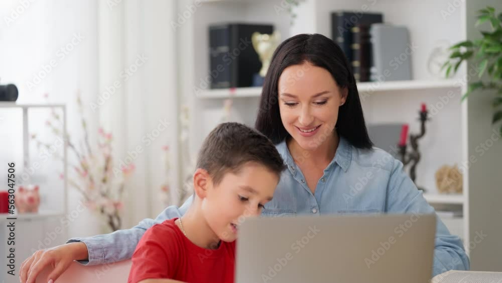 Little boy doing homework with his mother, education, positive reinforcement Little boy doing homework with his mother, education, positive reinforcement