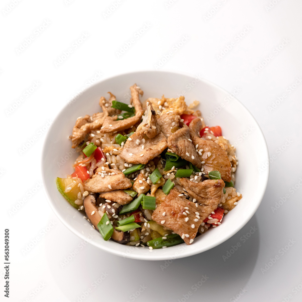 Udon noodles with chicken teriyaki, mushrooms, vegetables and sesame seeds. Asian cuisine. Dish on white background. Top view. Udon noodles with chicken teriyaki, mushrooms, vegetables and sesame seeds. Asian cuisine. Dish on white background. Top view.