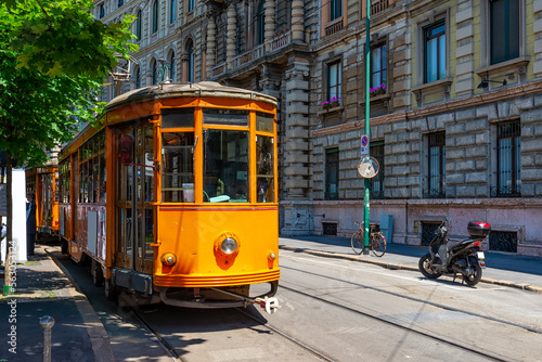 Old street with vintage tram in Milan, Italy. Architecture and landmarks of Milan. Cozy cityscape of Milan.