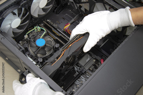 top view mechanic installing graphics card photo