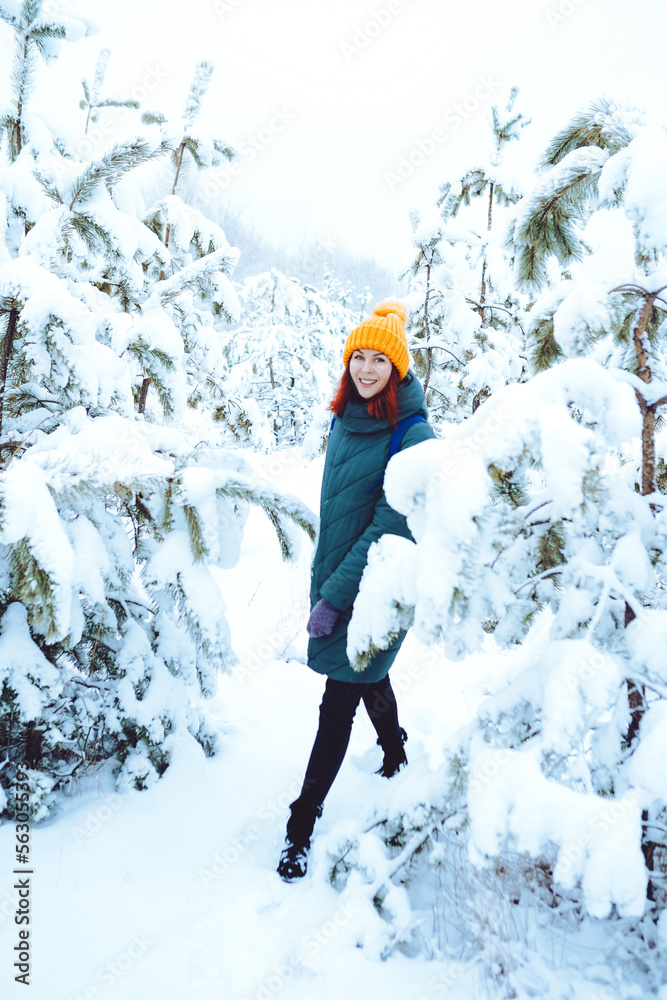 Young beautiful woman in winter forest