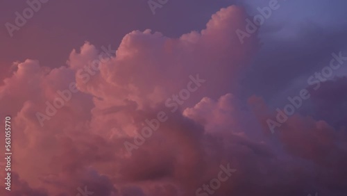 Breathtaking Timelapse video of dramatic clouds turning from yellow and grey to pink and dark red. Amazing sunset sky in crimson beams of sun. Film grain pixel texture. Nature climate background.