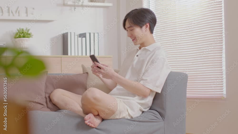 Asian man is smiling on the cellphone like he got a good news. The man seems so happy with the mobile phone screen. Technology make us have a convenience life and also make the world getting smaller. Asian man is smiling on the cellphone like he got a good news. The man seems so happy with the mobile phone screen. Technology make us have a convenience life and also make the world getting smaller.