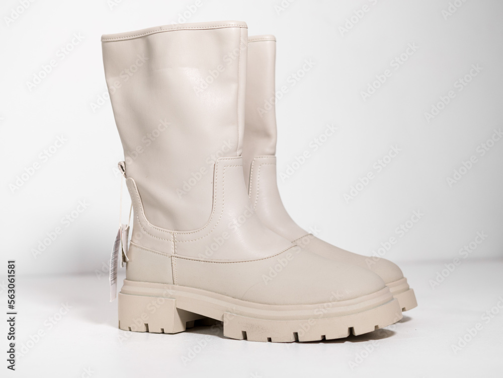 kent,uk 01.01.2023 ZARA cream and vanilla long ankle zip chunky track sole  high fashion boots. On trend catwalk footwear and sneakers. Women high  grade fashion brands. Photos | Adobe Stock
