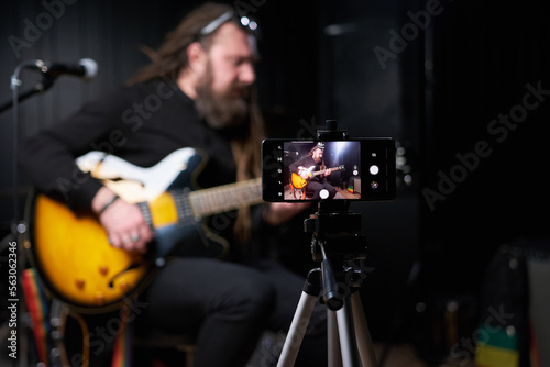 Guitarist man plays an electric guitar Close-up at studio