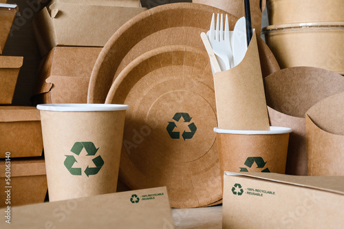 Eco-friendly disposable tableware made of biodegradable paper with a recycling sign. Close-up, selective focus on a plate with a sign. photo