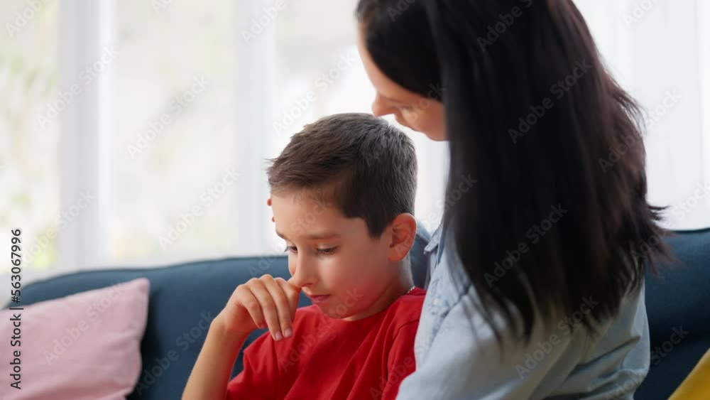 Caring mother hugging her upset son, bonding relationship, parent's protection Caring mother hugging her upset son, bonding relationship, parent's protection