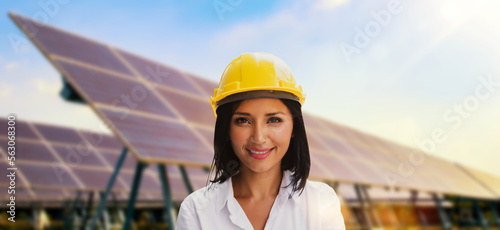 Beautiful cauasian female in yellow helmet working solar panel renewable energy clean energy green energy photovoltaic large scale solar panel power station provides supply power to urban industrial. photo