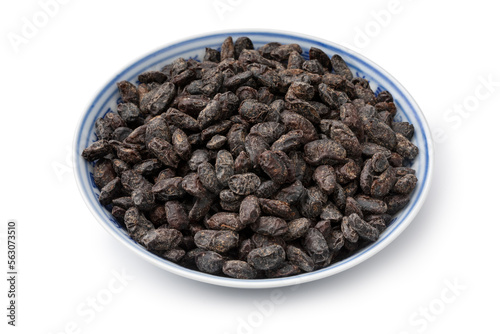 Bowl with Chinese salted black beans close up isolated on white background photo