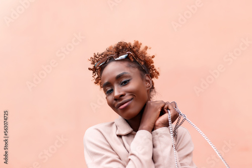 Beauty happy woman in a colorful wall looking at camera photo