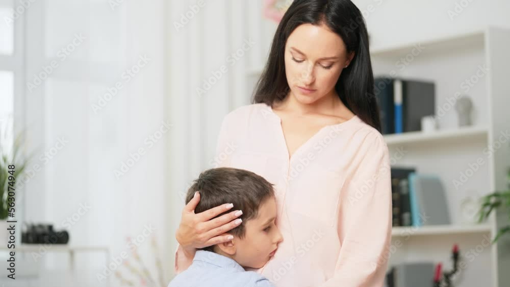 Little boy with problems at school hugging his mom, mother's support and love Little boy with problems at school hugging his mom, mother's support and love