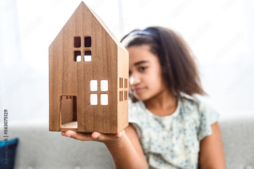 Pretty child girl lay on sofa at home with house on hand Pretty child girl lay on sofa at home with house on hand