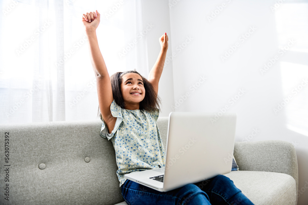 portrait of cute child using laptop on sofa portrait of cute child using laptop on sofa