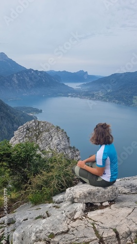 girl sitting on top of a mountain