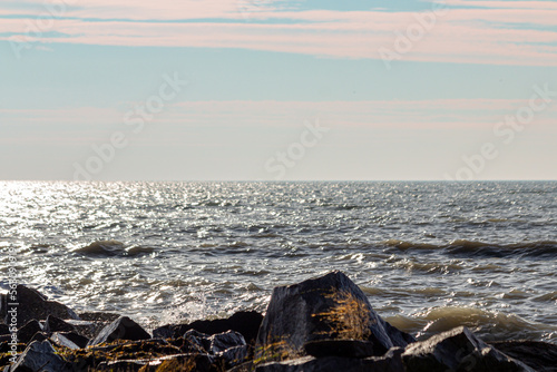 a beautiful seashore with a wave and big stones