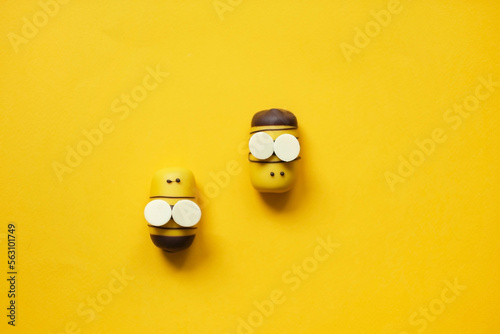 Flat lay bee cake pops on a yellow background. Top view Fototapet