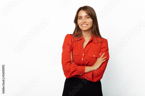 Handsome modern confident woman is standing with arms crossed over white background.