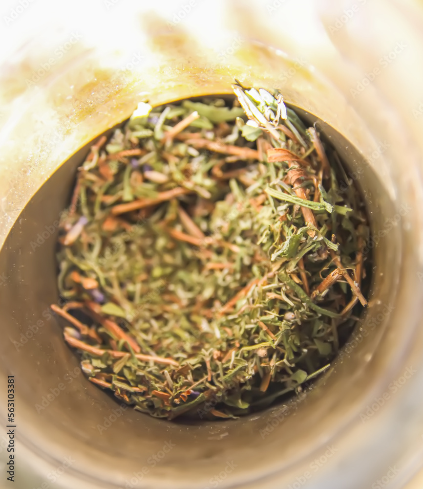 Obraz premium Medicinal herbs and flowers in a cooper mortar.