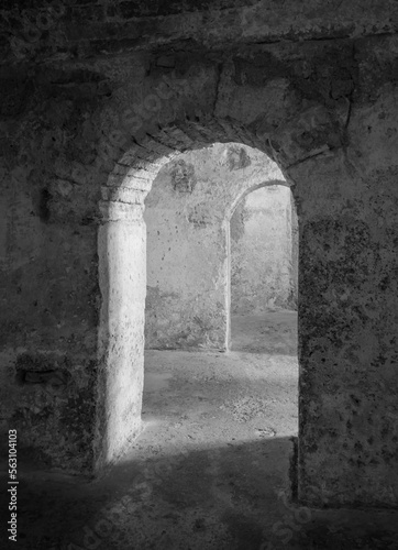 Black and white image of arches in the Alcazaba, the Moorish castle of Almeria City in Andalusia, Spain