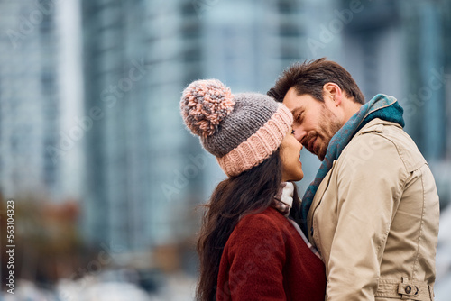 Couple in love about to kiss while spending time together outdoors.