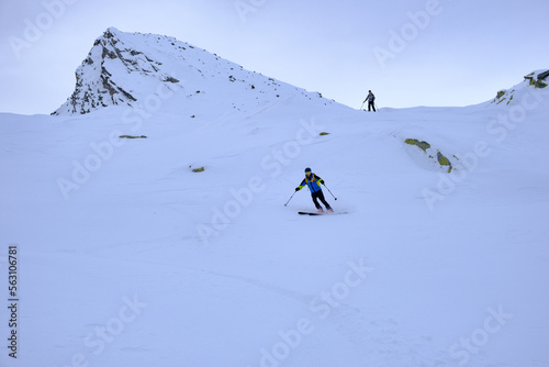 Sci alpinisti in discesa dal Pizzo dell'Uomo, Alpi Lepontine, Massiccio del San Gottardo, Svizzera photo