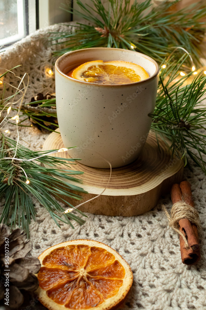 Green tea, Christmas tree branches, dried oranges, cloth mat Green tea, Christmas tree branches, dried oranges, cloth mat