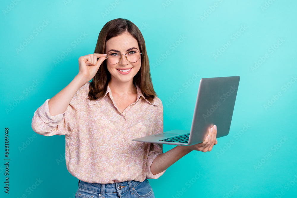Photo of confident sweet lady wear pink shirt spectacles communicating modern gadget isolated turquoise color background Photo of confident sweet lady wear pink shirt spectacles communicating modern gadget isolated turquoise color background
