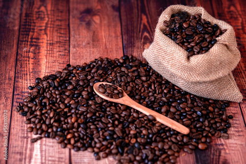 coffee beans on wooden table and wooden spoon