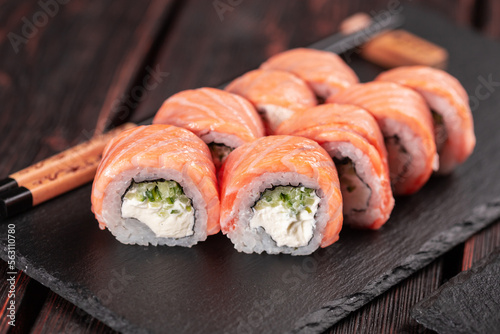 Sushi roll philadelphia with tuna and cucumber and cream cheese on black background. Sushi menu. Japanese food concept