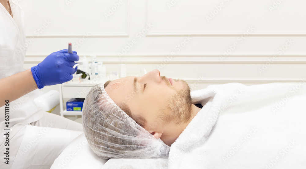 young man in the doctor's office for cosmetic procedures ,dermatologist offices,laser technology. young man in the doctor's office for cosmetic procedures ,dermatologist offices,laser technology.