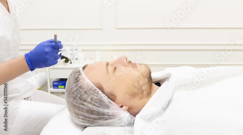 young man in the doctor's office for cosmetic procedures ,dermatologist offices,laser technology.