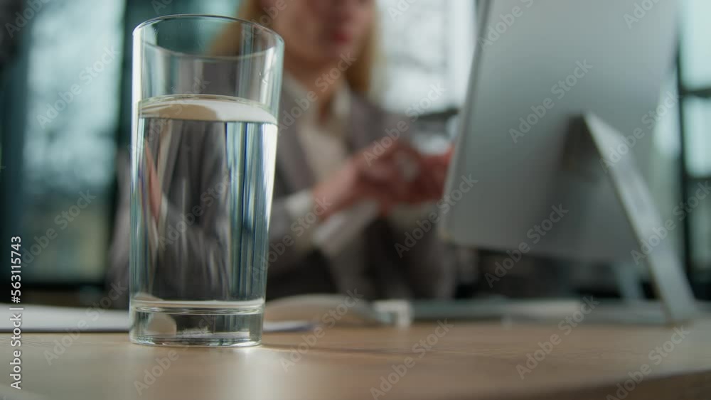 Blurred businesswoman office worker woman on background throw dizzy pill dose remedy tablet in glass of water with at table unrecognizable female need painkiller drink sparkling liquid cure feel ache Blurred businesswoman office worker woman on background throw dizzy pill dose remedy tablet in glass of water with at table unrecognizable female need painkiller drink sparkling liquid cure feel ache