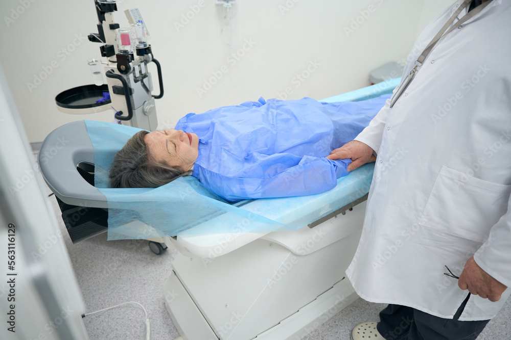 Diagnostician morally supports elderly patient before CT scan of brain Diagnostician morally supports elderly patient before CT scan of brain