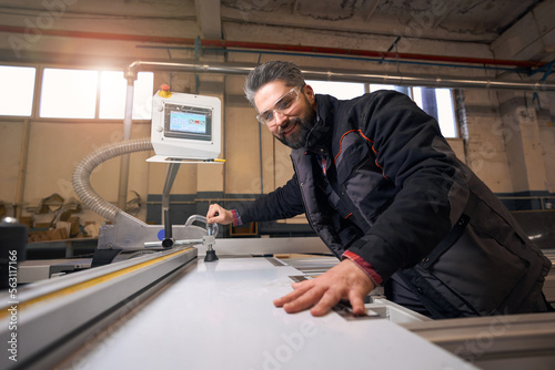 Man working with wood, checking quality of material