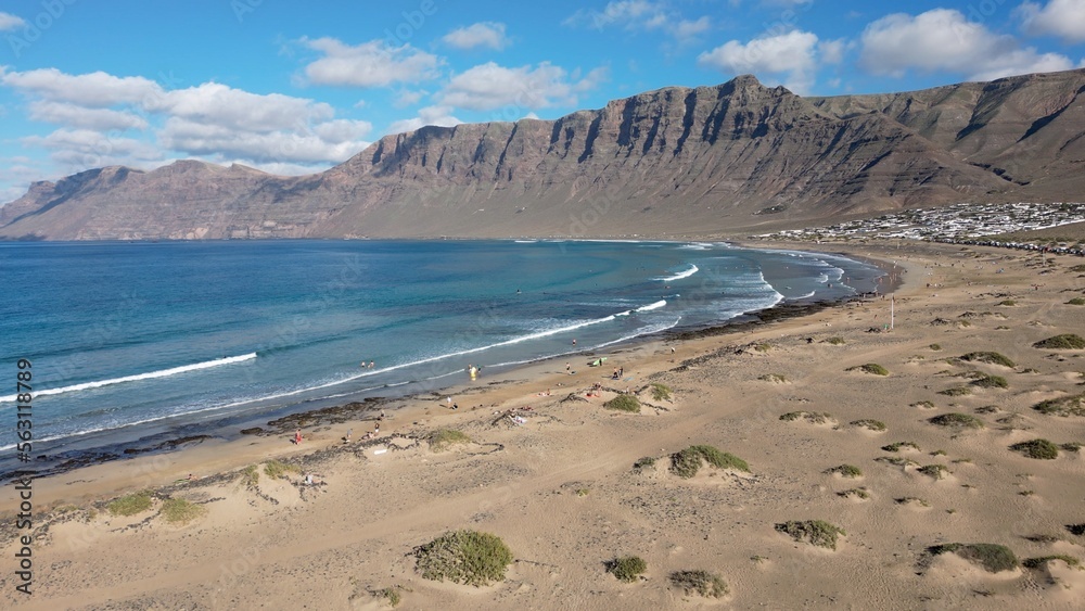 Europe, Spain, Lanzarote, Canary Islands - drone aerial view of the amazing ocean beach of Famara Famara the main mountainous massif in the north of the island of Lanzarote in the Canary Islands