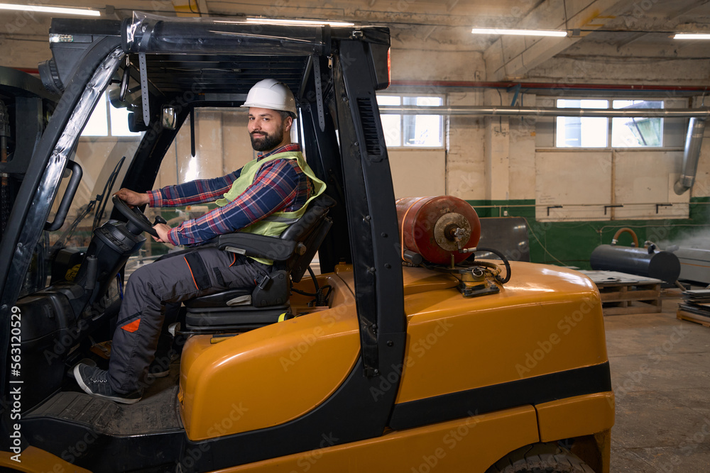 Professional loader transporting goods by car in the workshop Professional loader transporting goods by car in the workshop