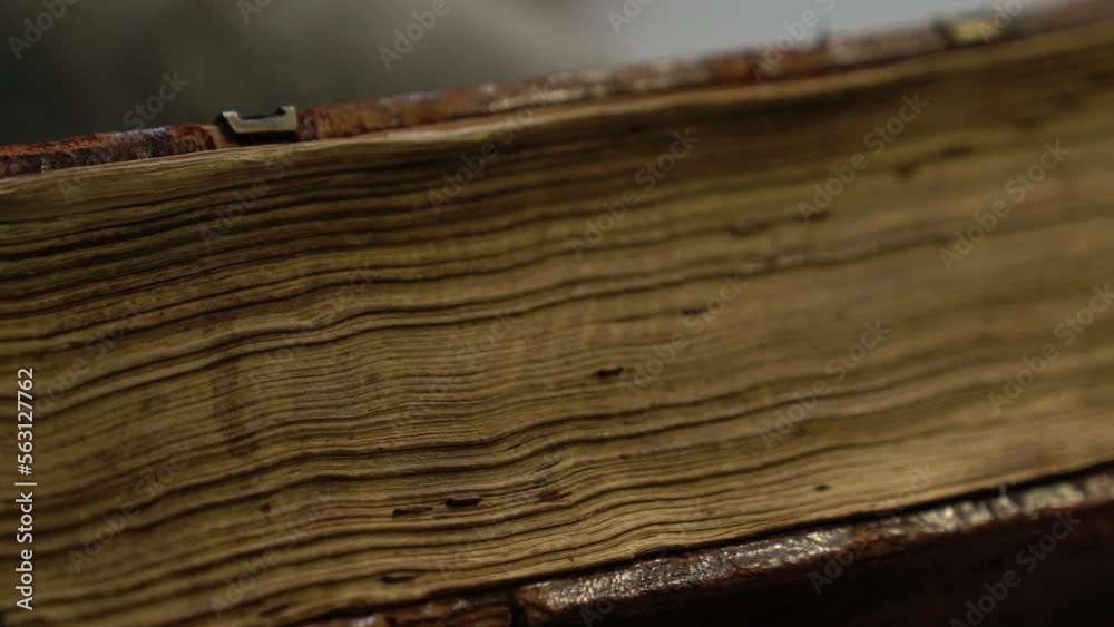 Antique book edge with dark brown thick cover and thorn yellowed pages ...