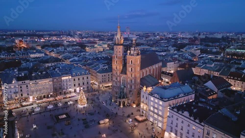 Kościół Mariacki - lot dronem w nocy wokół wież kościoła nad Rynkiem Głównym w Krakowie. W tle zamek na Wawelu i Sukiennice. photo